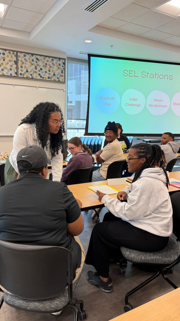 Emani talking with participants during a small-group SEL activity.